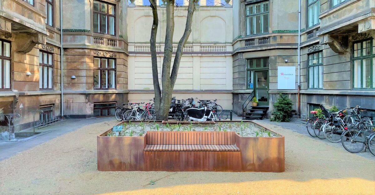 en unik plantekasse i cortenstål med en bænk af mahogni planker på Frederiksbergs gade